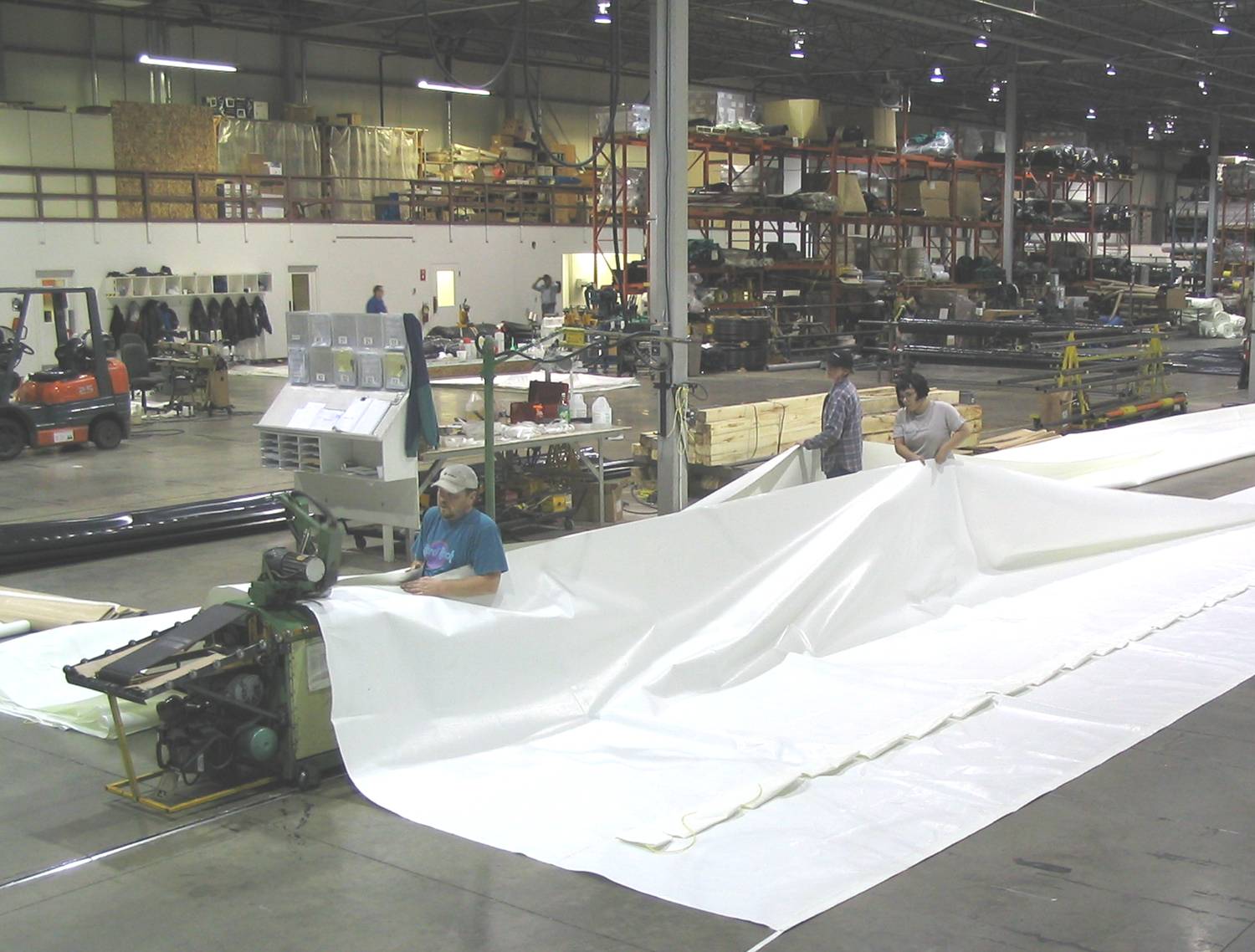 A fabric building cover is being welded together with a travelling hot-air welder.