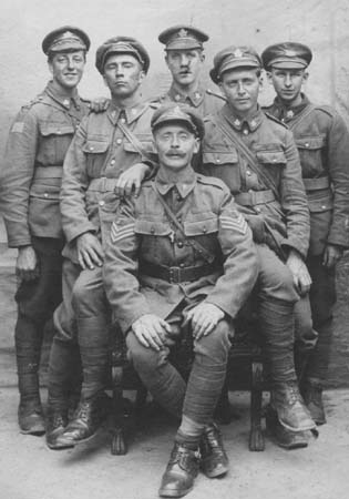 James Ira Mills (seated) and his brother Wilfred (first on right) in 1917.